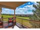 Inviting covered deck overlooking a manicured lawn and stunning golf course views at 6638 S Tibet Ct, Aurora, CO 80016