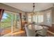 Dining room with hardwood floors, natural lighting, and access to the deck at 6638 S Tibet Ct, Aurora, CO 80016