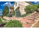 Home exterior featuring stone accents, layered landscaping, and stairway at 6638 S Tibet Ct, Aurora, CO 80016