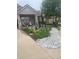 Landscaped front yard featuring stone accents and colorful flowerbeds at 6638 S Tibet Ct, Aurora, CO 80016