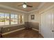 Cozy home office with hardwood floors, and natural light from large windows, perfect for a productive workspace at 6638 S Tibet Ct, Aurora, CO 80016