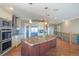 Modern kitchen featuring a large island, stainless steel appliances, and ample cabinet space at 6638 S Tibet Ct, Aurora, CO 80016