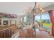 Open living space with fireplace, hardwood flooring, a view to the backyard, and stylish lighting at 6638 S Tibet Ct, Aurora, CO 80016