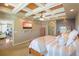 Large main bedroom featuring tray ceilings, a ceiling fan, and a modern television for entertainment at 6638 S Tibet Ct, Aurora, CO 80016