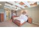 Spacious main bedroom boasts coffered ceilings, a ceiling fan, and an elegant, neutral color palette at 6638 S Tibet Ct, Aurora, CO 80016