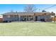 Expansive backyard offers a covered patio area, perfect for outdoor entertaining and relaxation, with a spacious lawn at 3461 S Ivy Way, Denver, CO 80222