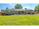 A large backyard with a patio and a lush green lawn, perfect for outdoor activities at 3461 S Ivy Way, Denver, CO 80222