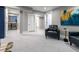 Spacious basement featuring stylish decor, including a dark leather chair and an abstract painting at 3461 S Ivy Way, Denver, CO 80222