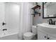 Bright bathroom with white subway tile, modern vanity, and shower-tub combo at 3461 S Ivy Way, Denver, CO 80222
