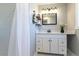 Bright bathroom with a shower, vanity and black framed mirror at 3461 S Ivy Way, Denver, CO 80222
