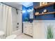 Stylish bathroom with blue accent wall and tiled shower at 3461 S Ivy Way, Denver, CO 80222