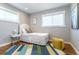 Well-lit bedroom featuring stylish decor and hardwood floors with a colorful area rug at 3461 S Ivy Way, Denver, CO 80222