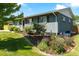 Lovely exterior view of a charming home with beautiful landscaping, plants, and grass at 3461 S Ivy Way, Denver, CO 80222