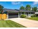 Charming single-story home boasts a well-maintained front yard and an attached two-car garage at 3461 S Ivy Way, Denver, CO 80222