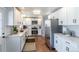 Modern kitchen with white cabinets, stainless steel appliances, and beautiful countertop at 3461 S Ivy Way, Denver, CO 80222