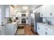 Modern kitchen with white cabinets, stainless steel appliances, and granite countertops at 3461 S Ivy Way, Denver, CO 80222