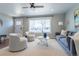 Bright living room featuring a ceiling fan and a stylish, comfortable seating area at 3461 S Ivy Way, Denver, CO 80222