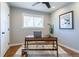 Home office setup with natural light, a modern desk, and hardwood floors at 3461 S Ivy Way, Denver, CO 80222