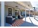 Relaxing outdoor patio with comfortable seating, an outdoor rug and an adjacent hot tub at 3461 S Ivy Way, Denver, CO 80222