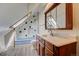 Bathroom with stylish vanity, framed mirror, and unique tiled shower at 458 S Downing St, Denver, CO 80209