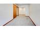 Spacious carpeted room with a wooden closet and an open adjacent space, offering versatility and comfort at 458 S Downing St, Denver, CO 80209