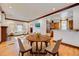 Open-concept dining area with hardwood floors, neutral decor, and views of the living spaces at 458 S Downing St, Denver, CO 80209