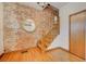 Entryway boasting exposed brick wall with mirror and wood stairs with natural light at 458 S Downing St, Denver, CO 80209