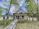 Charming front exterior of home with peaked roof, brick facade, and welcoming front porch at 458 S Downing St, Denver, CO 80209