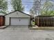 Detached garage exterior, showcasing a single-car garage with a white door and adjacent wooden fence at 458 S Downing St, Denver, CO 80209