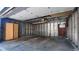 Spacious garage interior with concrete floor, wood frame walls, and a door to the backyard at 458 S Downing St, Denver, CO 80209