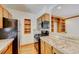 A bright kitchen featuring wooden cabinets, countertops, and modern black appliances, including a microwave and oven at 458 S Downing St, Denver, CO 80209