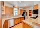 Traditional kitchen featuring wood cabinets, granite countertops, stainless steel appliances, and a window over the sink at 458 S Downing St, Denver, CO 80209