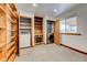 Cozy laundry room fitted with built-in wooden shelves, washer, dryer, and window providing natural light at 458 S Downing St, Denver, CO 80209
