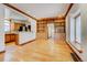 Open-concept living room showcasing hardwood floors, and decorative wooden shelving, with a kitchen view at 458 S Downing St, Denver, CO 80209
