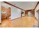 Spacious living room featuring hardwood floors, brick accent wall, and decorative trim at 458 S Downing St, Denver, CO 80209