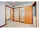 A spacious room with wooden shelving and a doorway, enhanced by neutral carpeting and a clean aesthetic at 458 S Downing St, Denver, CO 80209