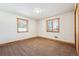 This spacious bedroom features natural light from two windows at 9019 Armadillo Trl, Evergreen, CO 80439