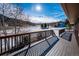 Spacious wood deck overlooking a snow-covered field and neighborhood at 9019 Armadillo Trl, Evergreen, CO 80439