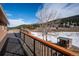 View from the deck showing the surrounding landscape, shed, and open space at 9019 Armadillo Trl, Evergreen, CO 80439