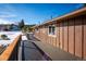 Exterior view of the house with wood siding and a deck with wood railing at 9019 Armadillo Trl, Evergreen, CO 80439