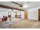 Unfinished garage with a workbench, exposed beams, and concrete floors at 9019 Armadillo Trl, Evergreen, CO 80439