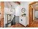 Foyer entrance with wood accents, beamed ceilings, and modern decor at 9019 Armadillo Trl, Evergreen, CO 80439