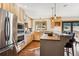 This kitchen features stainless appliances, wood cabinets, and a central island, perfect for entertaining at 9019 Armadillo Trl, Evergreen, CO 80439