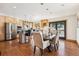 Spacious kitchen and dining area features wood cabinets, stainless steel appliances, and scenic views at 9019 Armadillo Trl, Evergreen, CO 80439