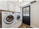 Laundry room with washer, dryer, and white cabinets at 9019 Armadillo Trl, Evergreen, CO 80439