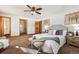 Sunlit main bedroom featuring a ceiling fan and large walk-in closet at 9019 Armadillo Trl, Evergreen, CO 80439