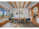Dining room with exposed beams, chandelier, artwork and large window with view at 1420 Sierra Dr, Boulder, CO 80302