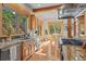 Bright kitchen with wood cabinets, stone countertops, stainless appliances, and dining area at 1420 Sierra Dr, Boulder, CO 80302