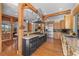 Large kitchen with custom cabinets, wooden beams, a central island, and stainless steel appliances at 1420 Sierra Dr, Boulder, CO 80302