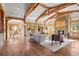 Living room featuring a stone fireplace, wood beams, and sliding doors to the outdoor space at 1420 Sierra Dr, Boulder, CO 80302